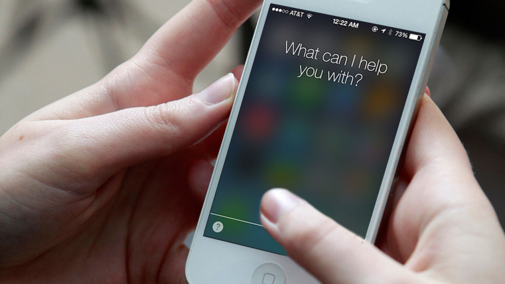 Hands holding an iPhone with Siri activated