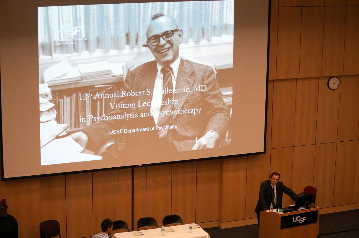 William Wolfe, MD, talking at podium