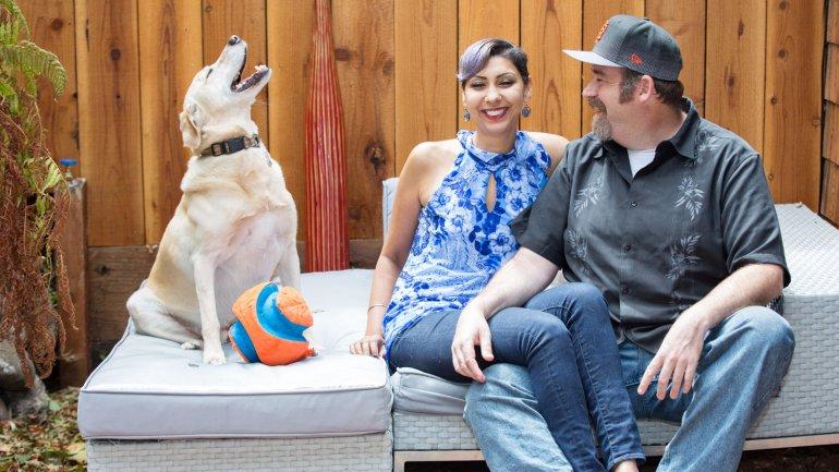 Grewal, husband, and dog sitting outside.