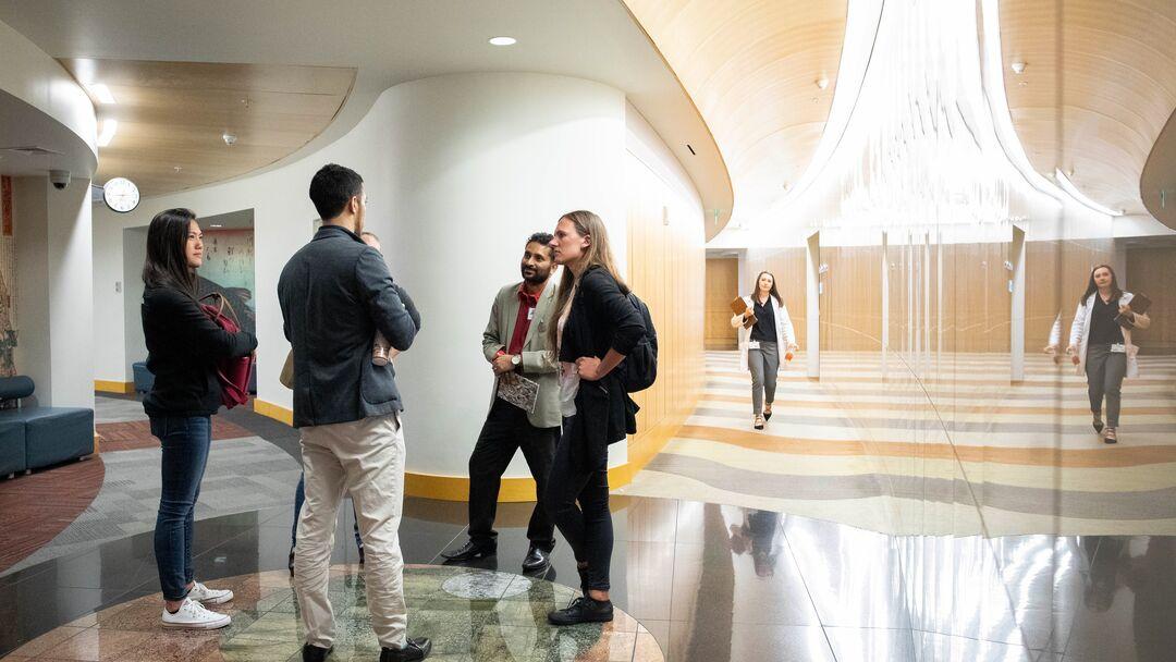 Postdocs talking in a hallway