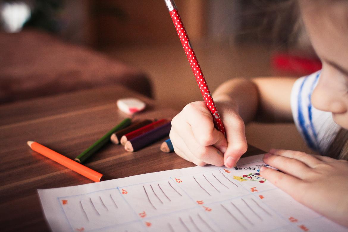 Child drawing on a piece of paper