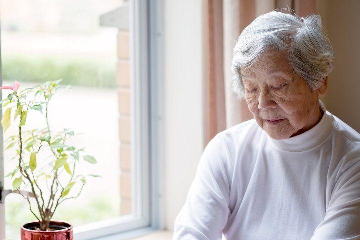 Elderly woman sitting by a window