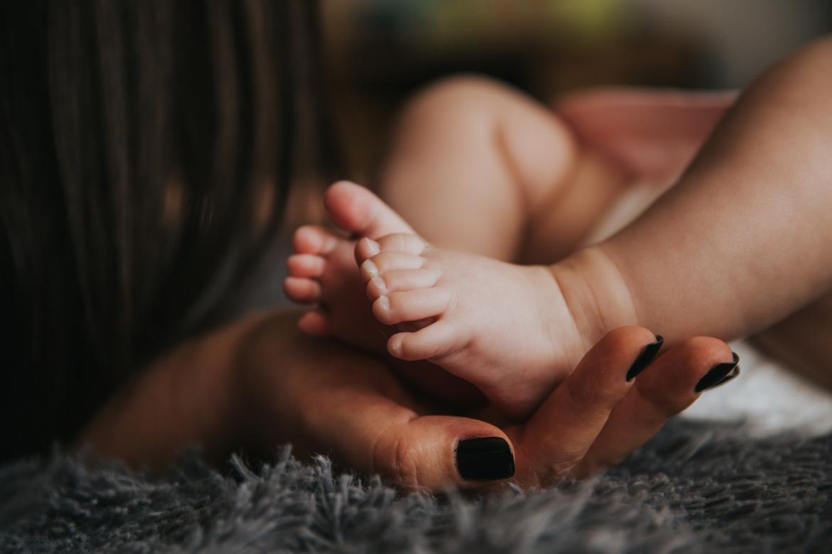 Baby's feet being cradled by a woman's hands