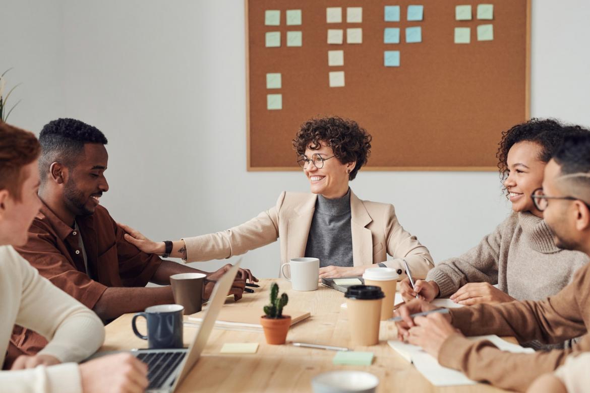 Employees seated around a table