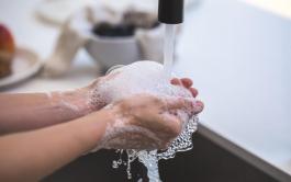 Person washing their hands under running water