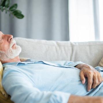 Older person sleeping on couch