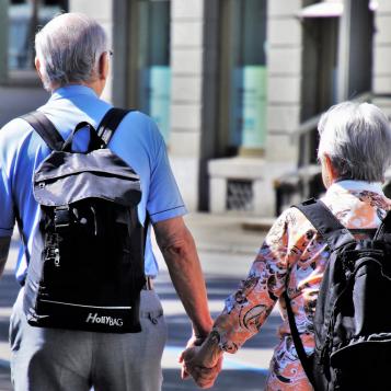Rear view of a senior adult couple holding hands